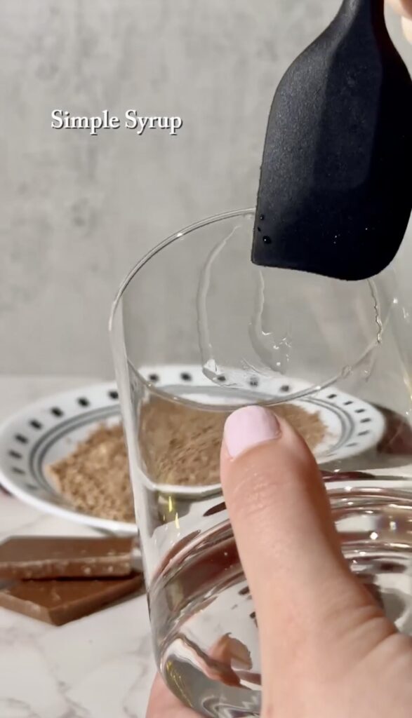 Adding simple syrup to garnish the glass of the Chocolate Cherry Cocktail